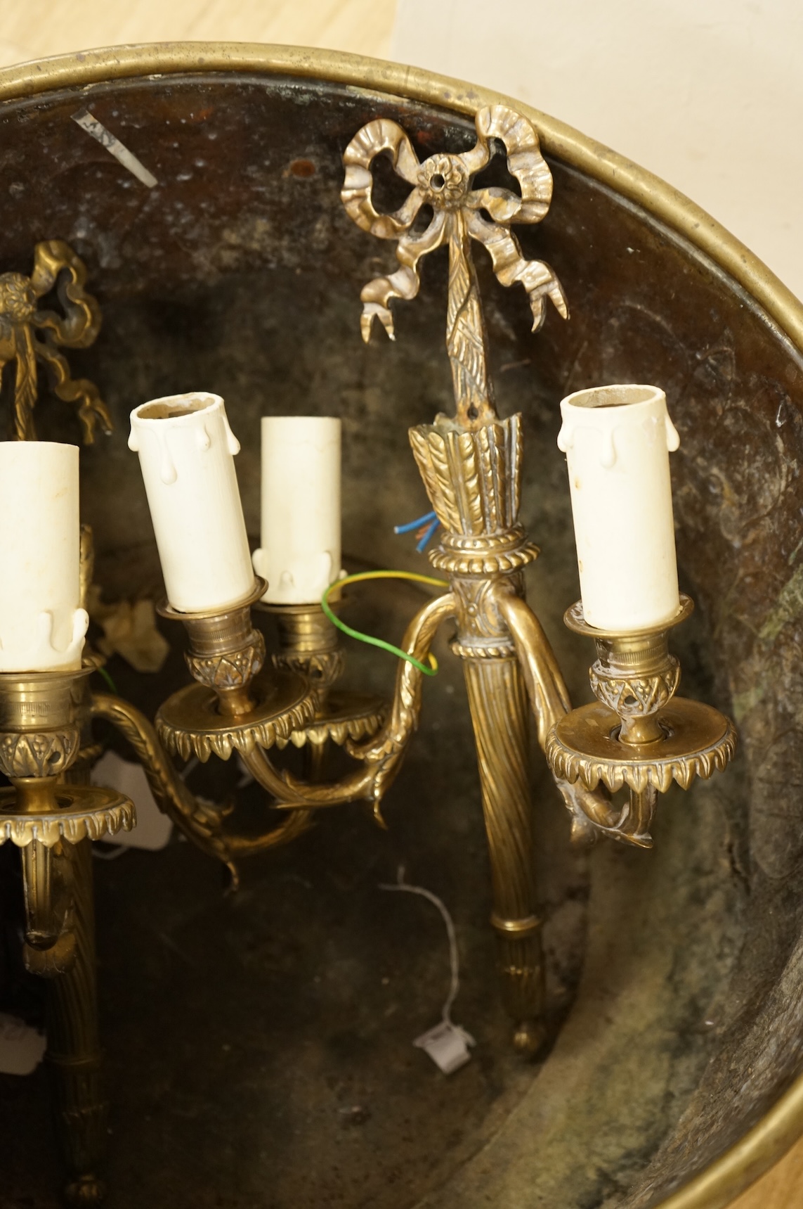 A 19th century Dutch brass coal bin, a pair of wall sconces, a copper bed warmer and three book slides
